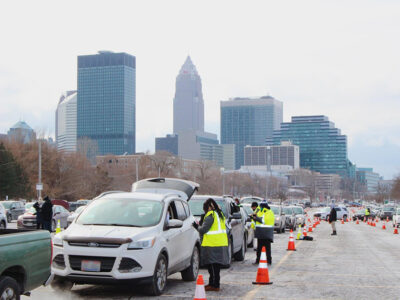 Drivers pull through a municipal lot in downtown Cleveland to pick up boxes from the food bank.