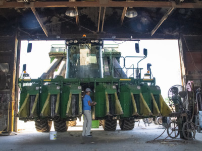 Farmer fixing combine john deere repair