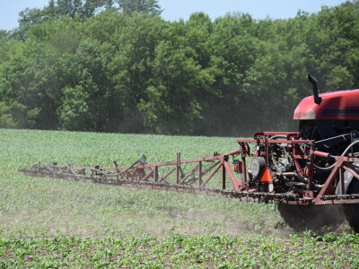 Tractor spraying fertilizer