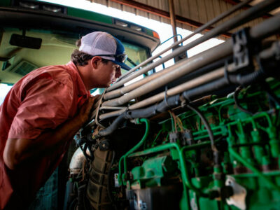 Farmer repairing a tractor